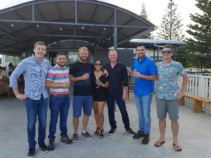 Group of people posing for photo outside