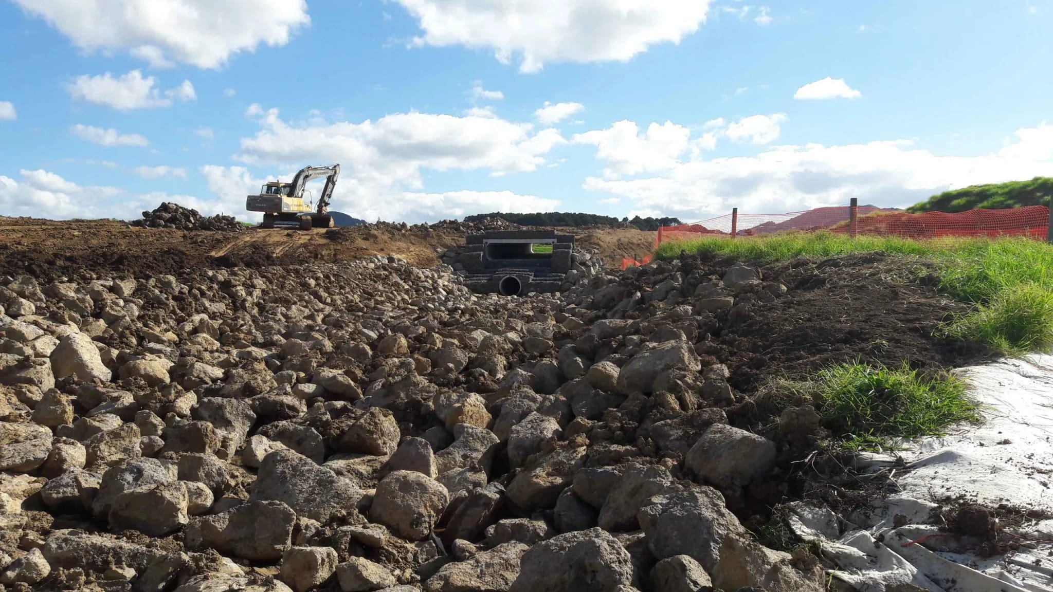 Aerial view of an excavator shaping a bulk earthworks platform