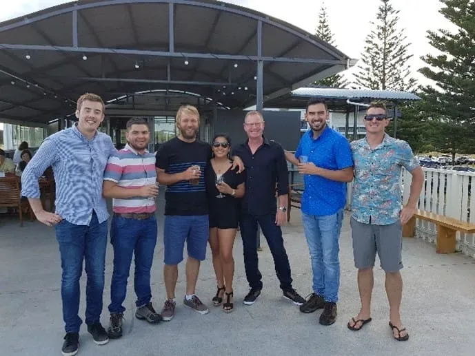 Group of people posing for photo outside