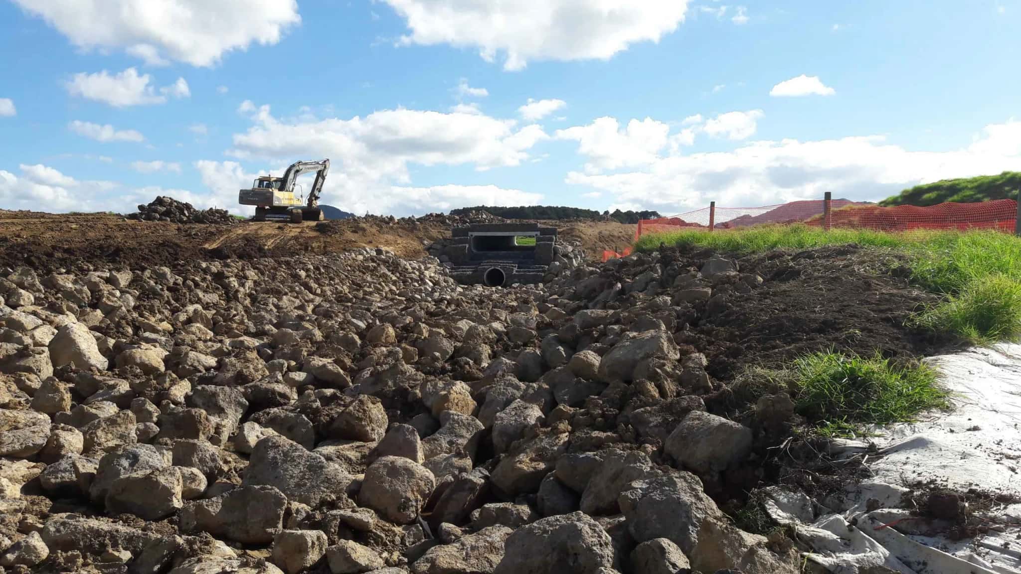 Aerial view of an excavator shaping a bulk earthworks platform