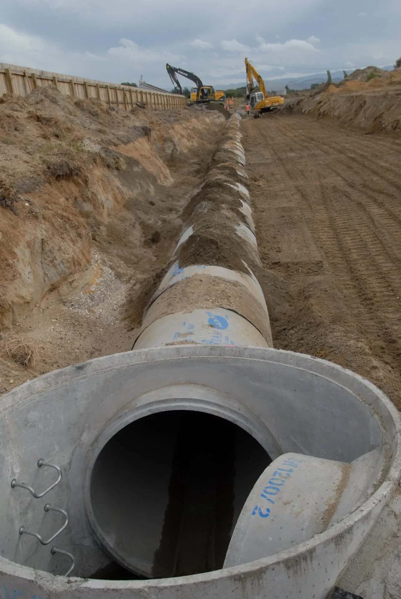 Large concrete pipe sections laid in an open trench