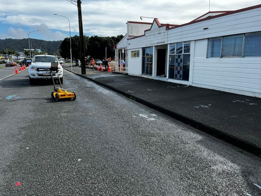 a white building with a gpr machine on the side of the road