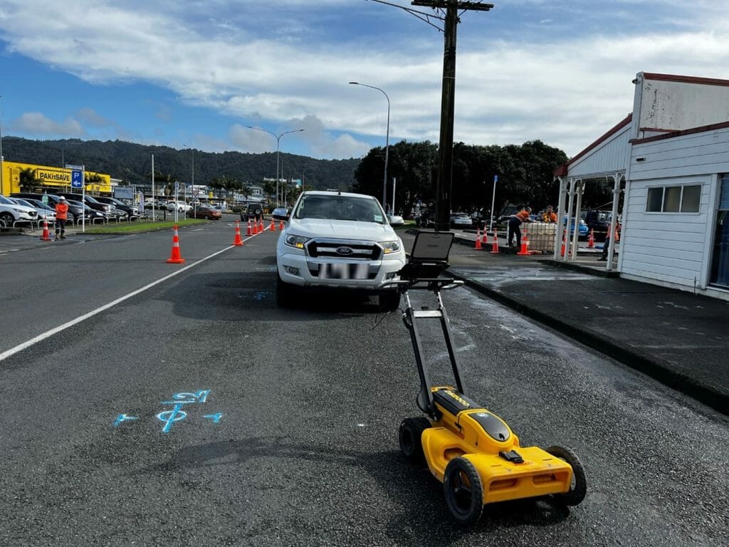 a car parked on the side of a road next to gpr machine.