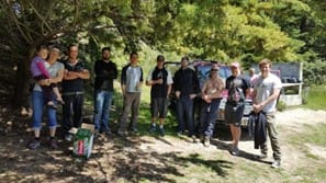 Group of people posing for photo under a tree