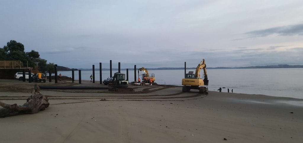 construction equipment on beach during wharf construction