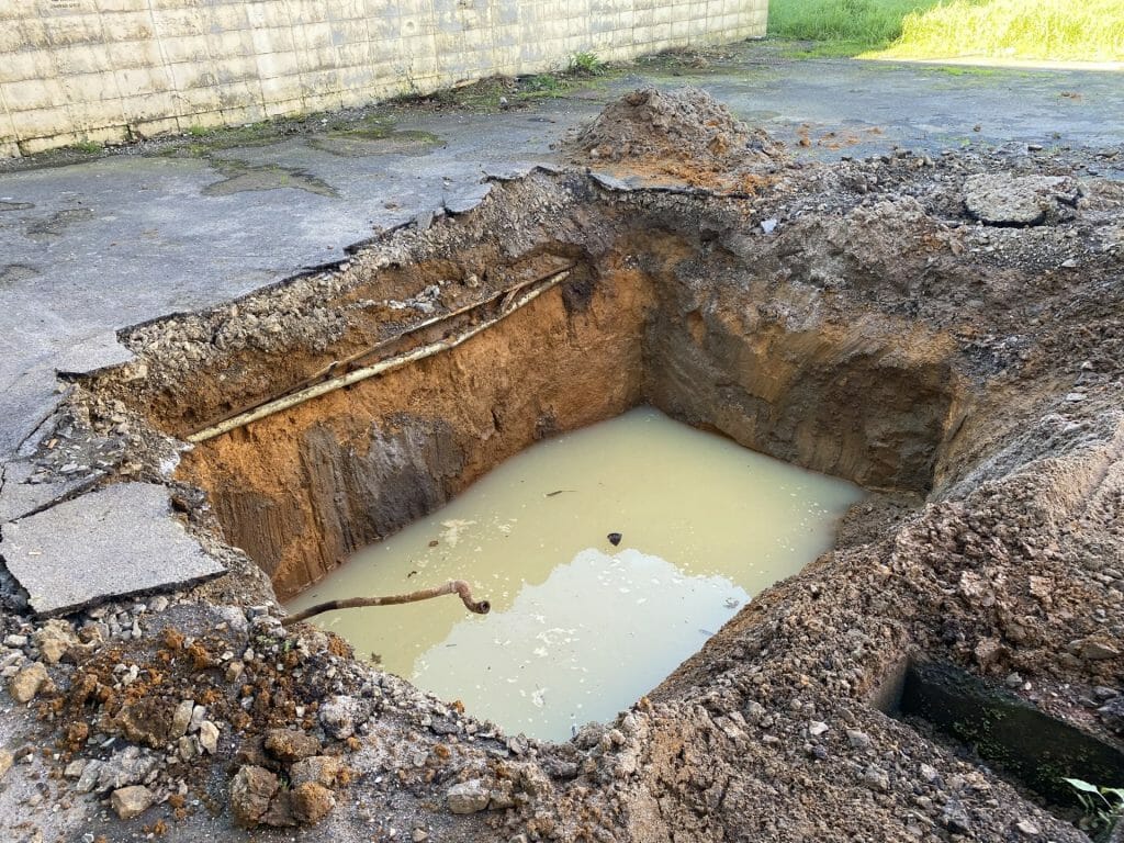 a hole partly filled with water.