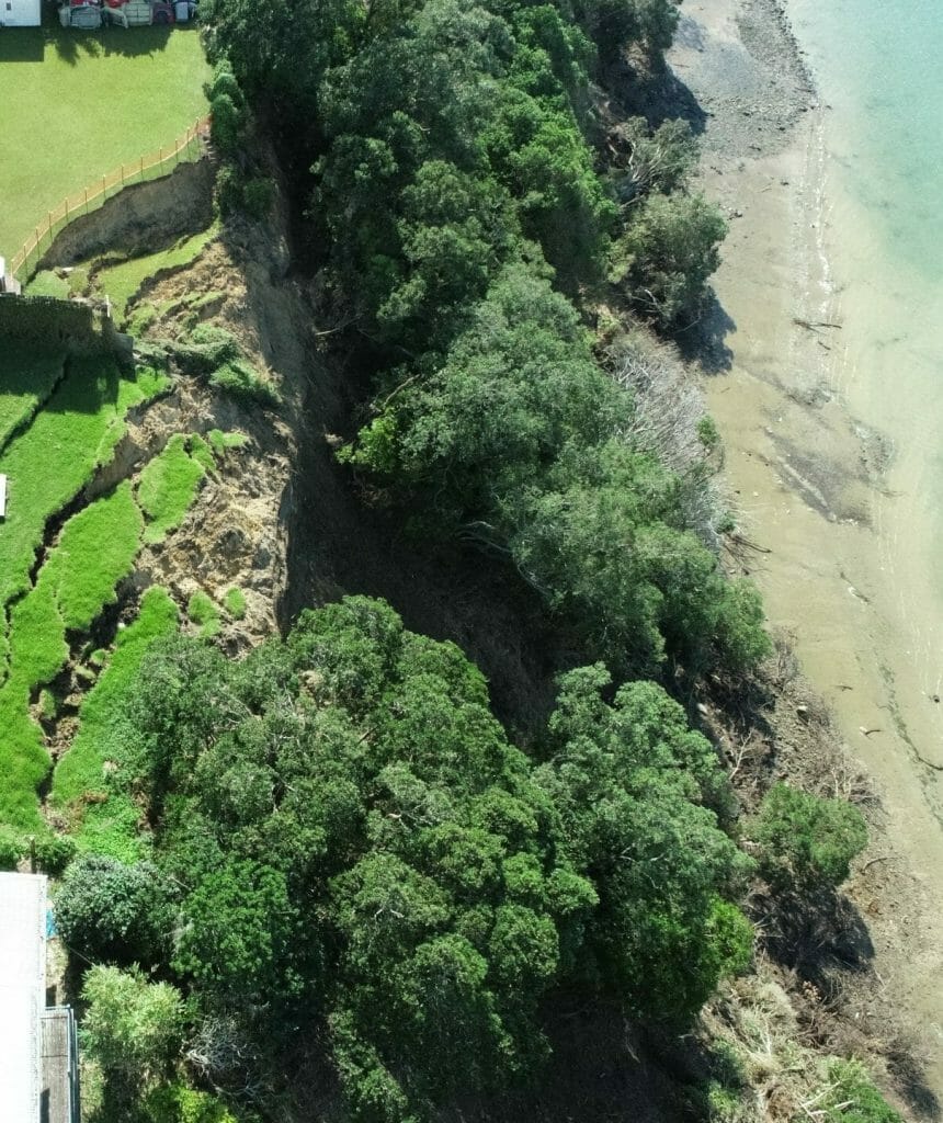aerial view of house near cliff landslide