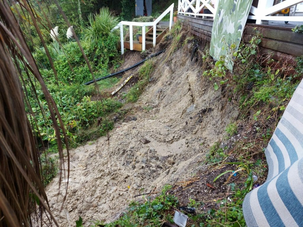Landslide next to wooden structure